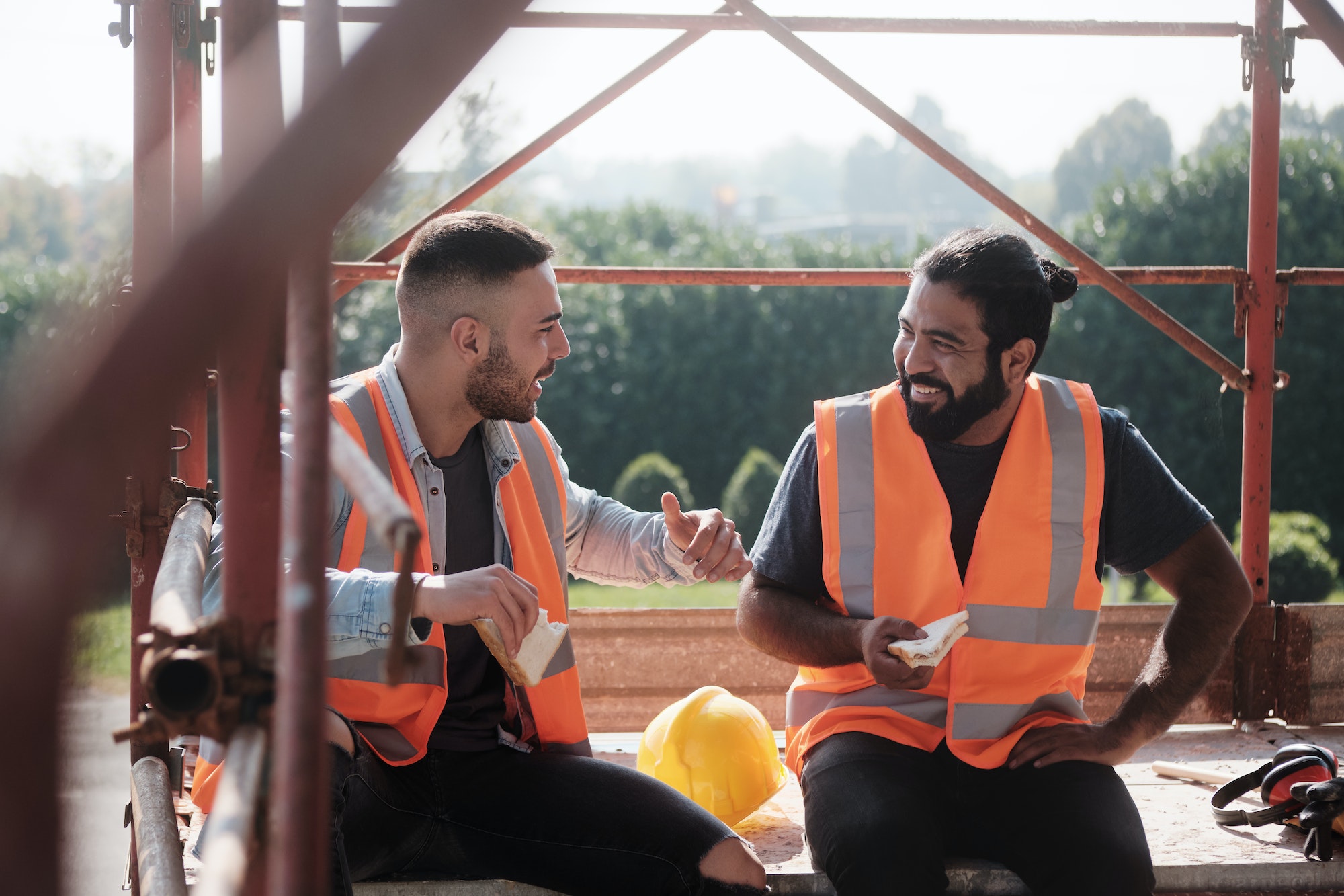 Happy Workers In Construction Site During Lunch Break